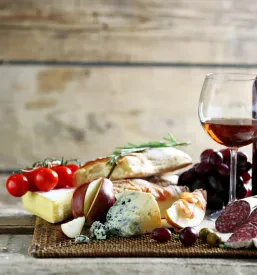 Bogata miza z raznovrstnimi italijanskimi dobrotami in izbranimi vini, primerna za kosila in zaključene družbe v Goriški regiji.