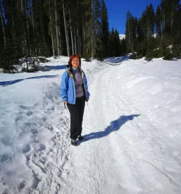 Moški z mišičasto postavo pozira z dumbbells utežmi, kar prikazuje rezultate redne telovadbe za zdravo življenje.