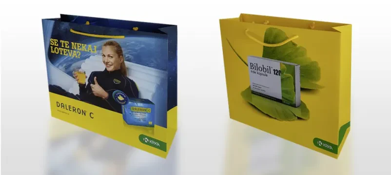 Vrsta svetlih papirnatih vrečk z logotipom podjetja Krka, ki predstavljajo personalizirane papirnate vrečke po naročilu Slovenija za farmacevtsko industrijo.